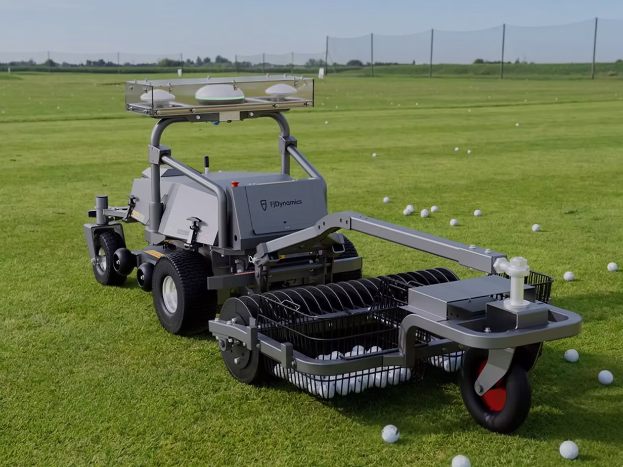 An autonomous mower retreives balls in a sports field